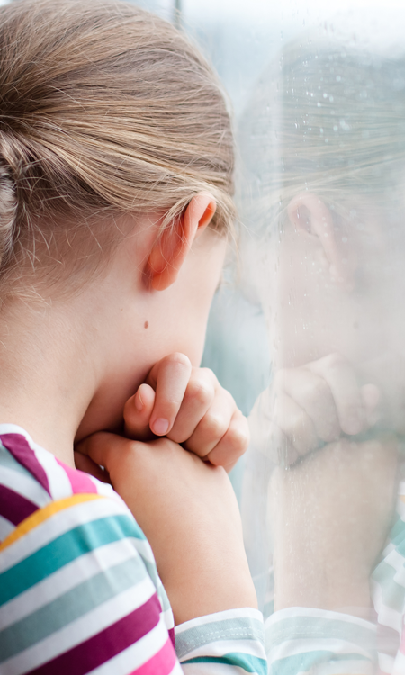 a young girl looking out a window