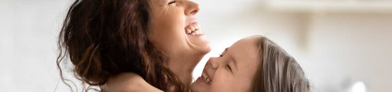 image banner of a parent and child hugging & smiling